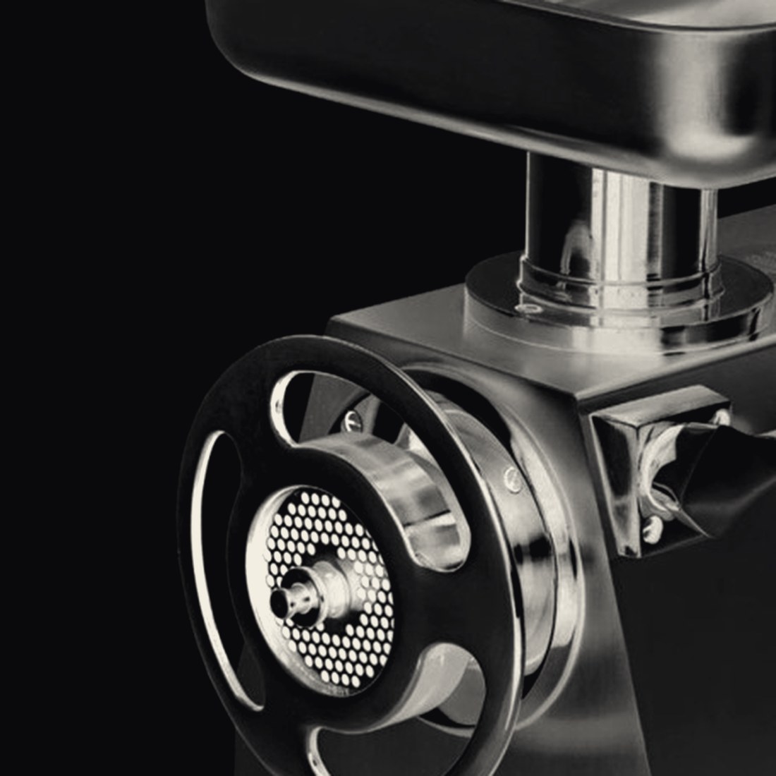 Professional stainless steel mincer, photographed against black